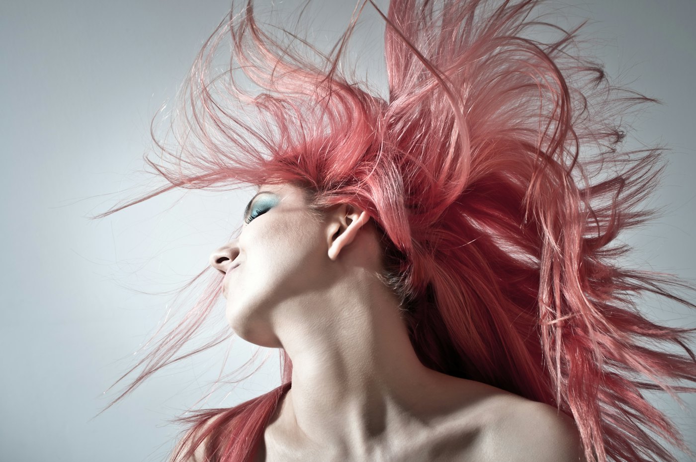 Vivid rose-pink fashion color caught mid hair-flip